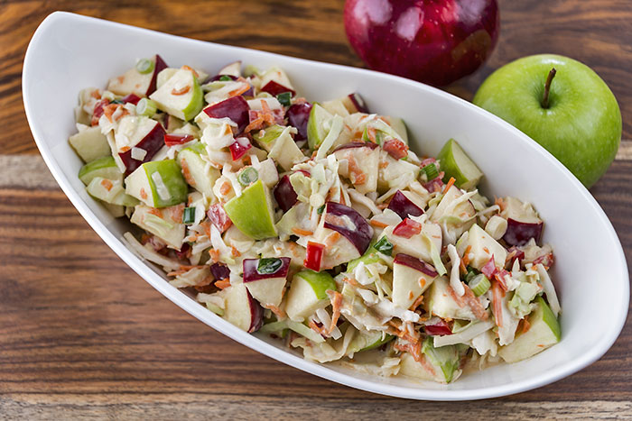 Apple Slaw With Honey Mustard Vinaigrette in a White Dish